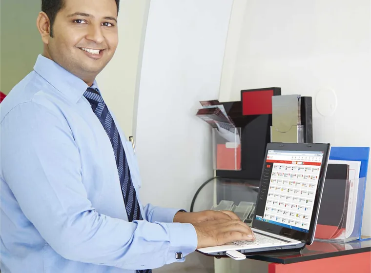 A SiOnline agent working at a desk with a laptop