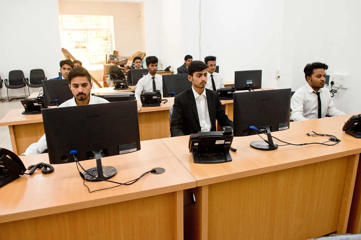 SiOnline support staff working at desks on the company's operations floor in Ratlam